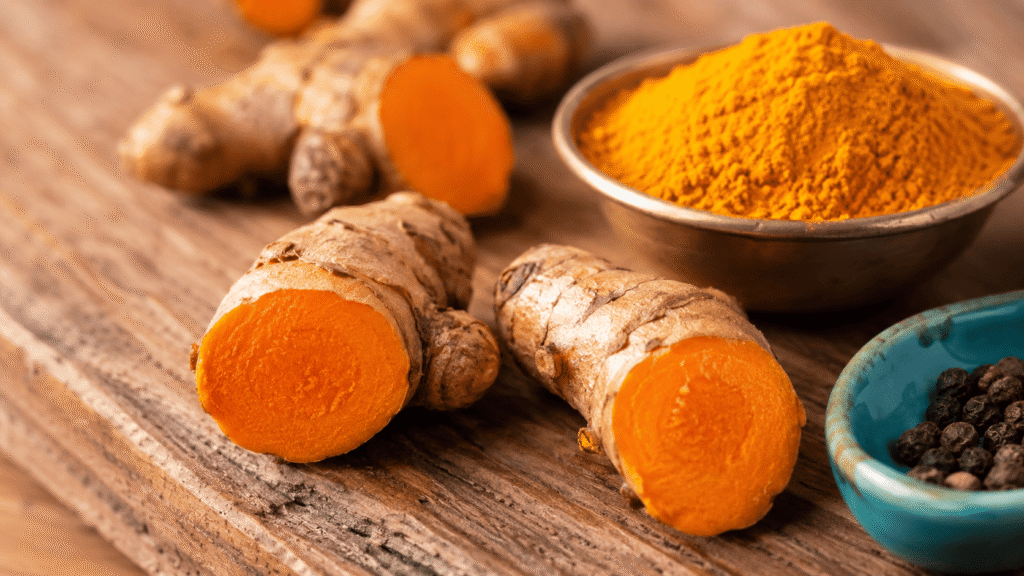 Fresh turmeric root and turmeric powder showing natural curcumin content